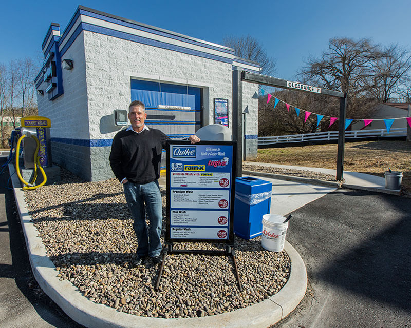 Quik-E Food Stores VP Todd Burgess stands outside a car wash