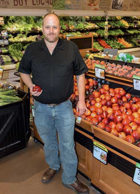 Image of a man holding an apple.