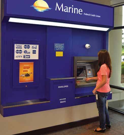 Image of a woman using a Marine Federal Credit Union ATM machine.