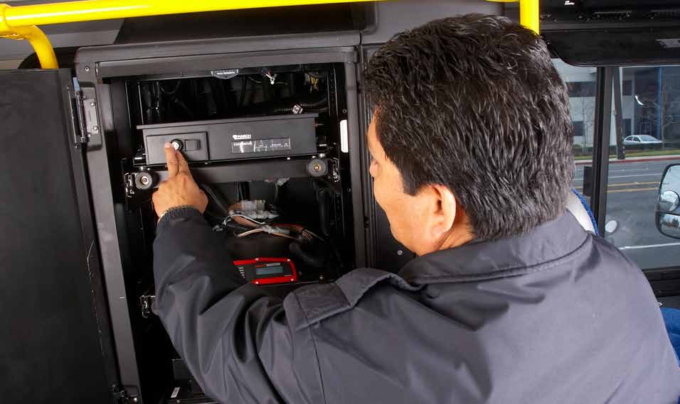 A bus driver accesses the compartment containing the March Networks 5308 mobile recorder.