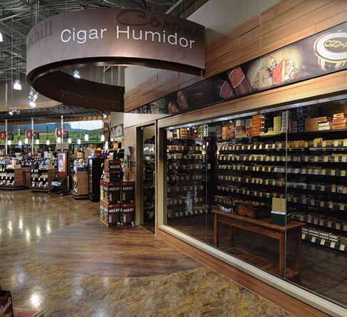 Image of an glass enclosed, humidity controlled cigar section in the wine store. 